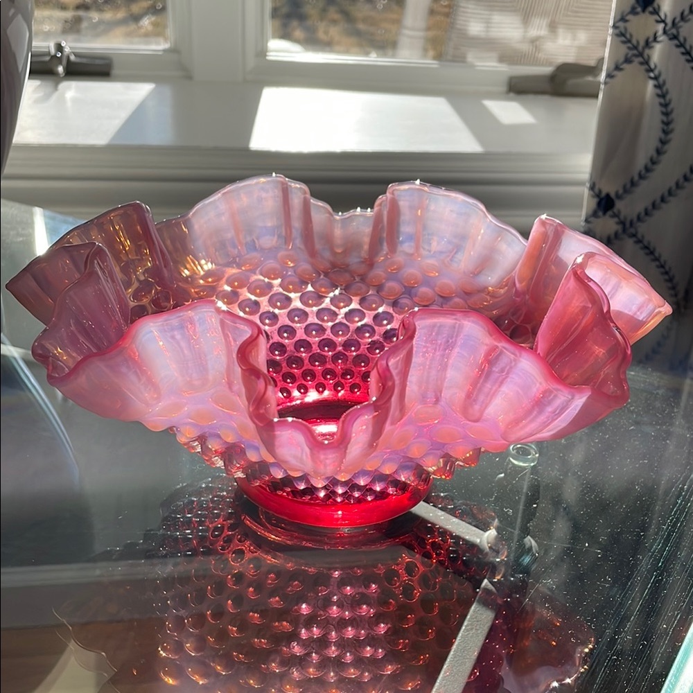This Fenton cranberry bowl is a stunning piece of mid-20th century art glass